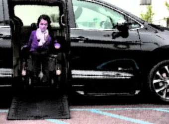 girl-wheelchair-getting-out-side-entry-wheelchair-van copy
