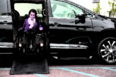 girl-wheelchair-getting-out-side-entry-wheelchair-van copy